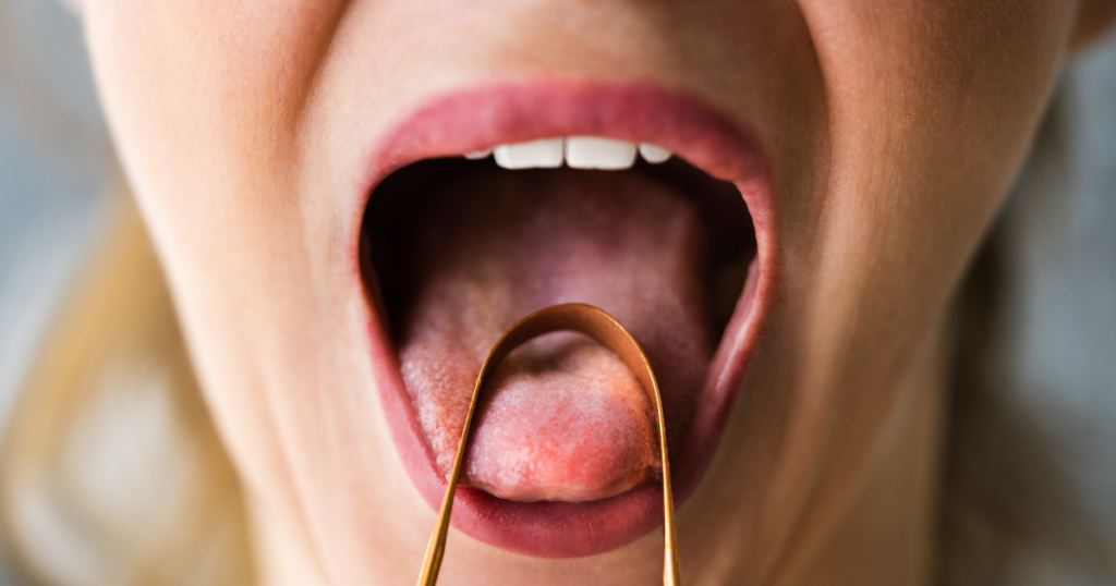 woman using a tongue scraper to get rid of bad breath