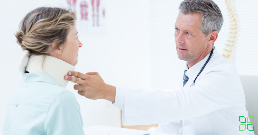 doctor putting neck brace on patient