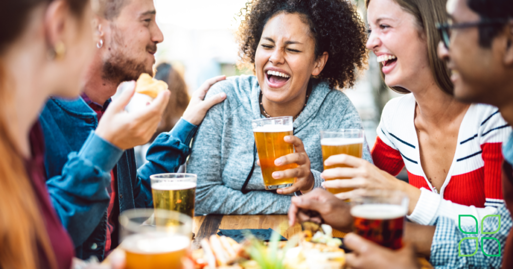 group laughing and enjoying food and drinks