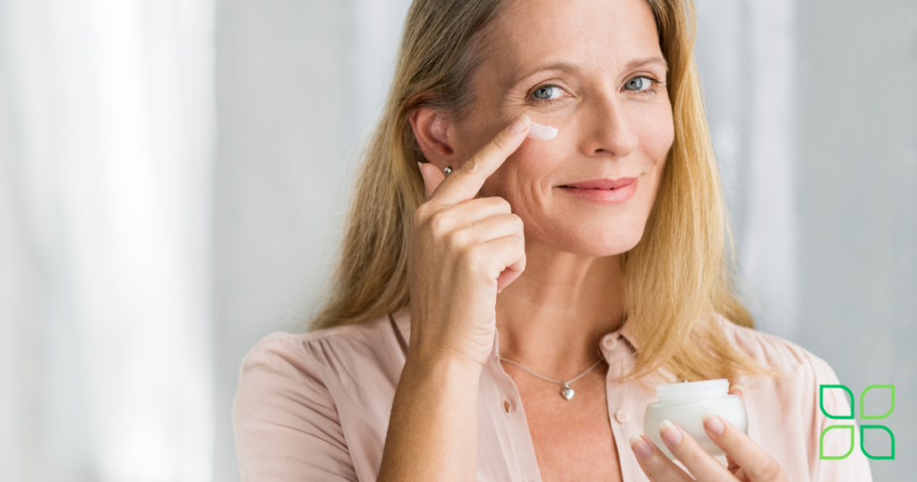 a woman putting on anti-aging cream on her face