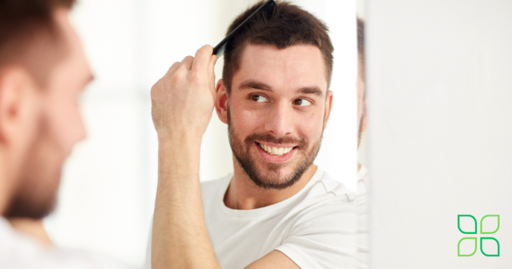 happy guy checking his hair line in the mirror